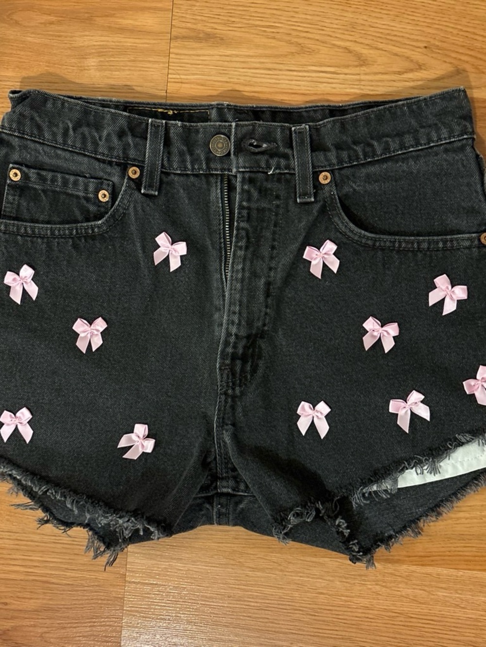 Levi's Black Denim Shorts with Pink Bow Embellishments